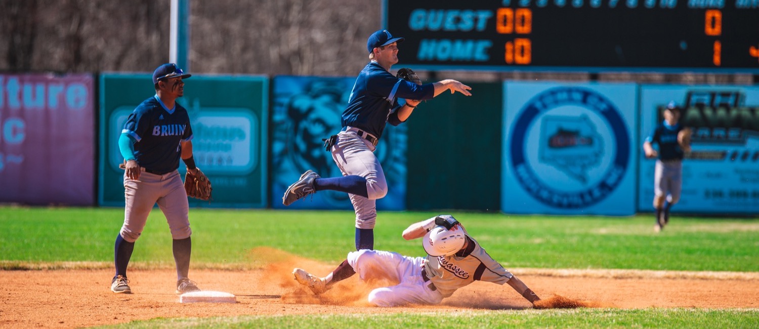 Baseball player sliding onto base