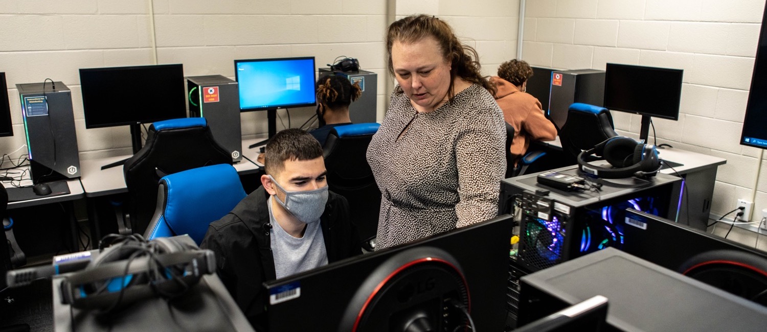 Esports teacher working with student